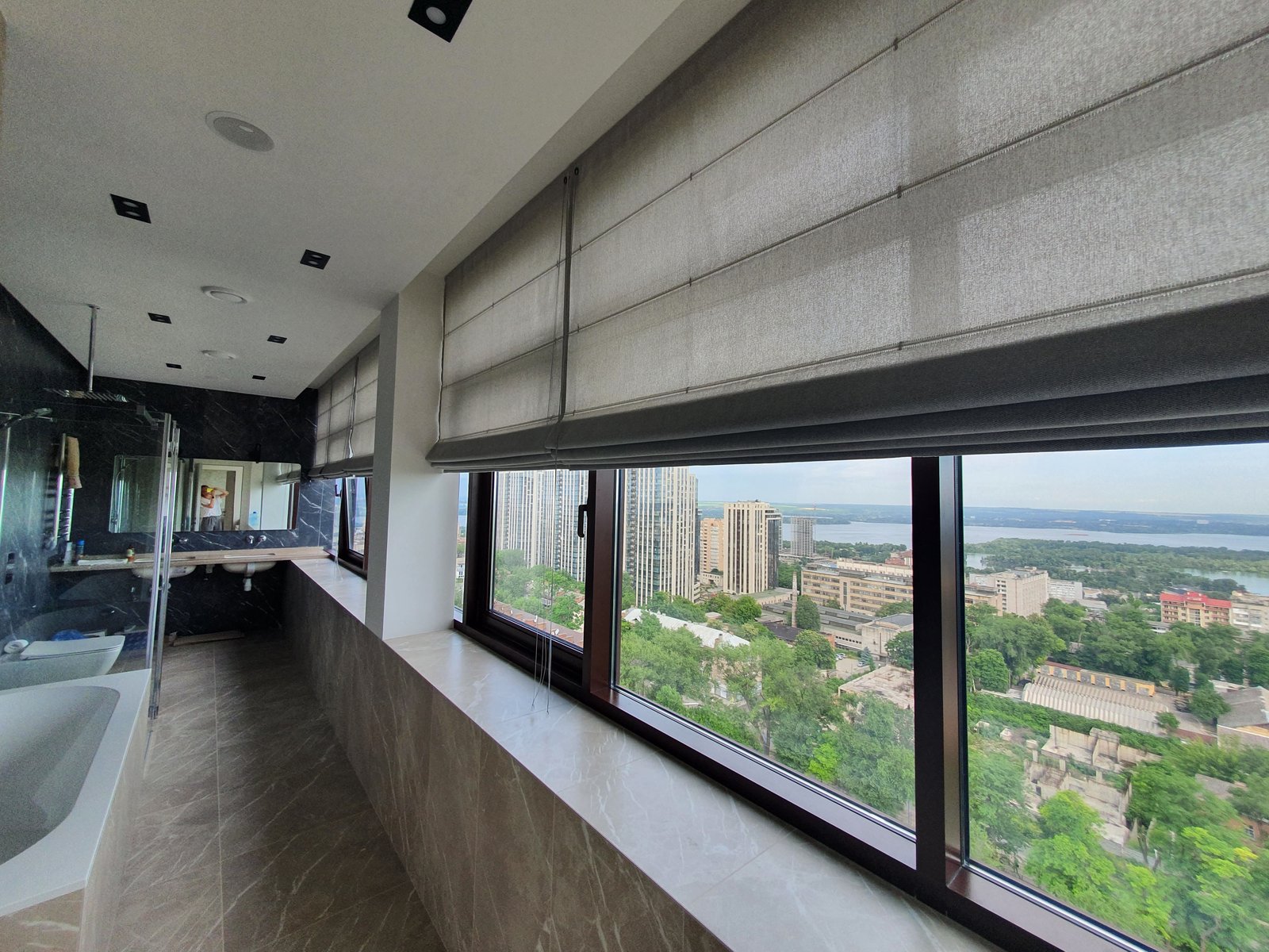 Panoramic roman blinds with city view