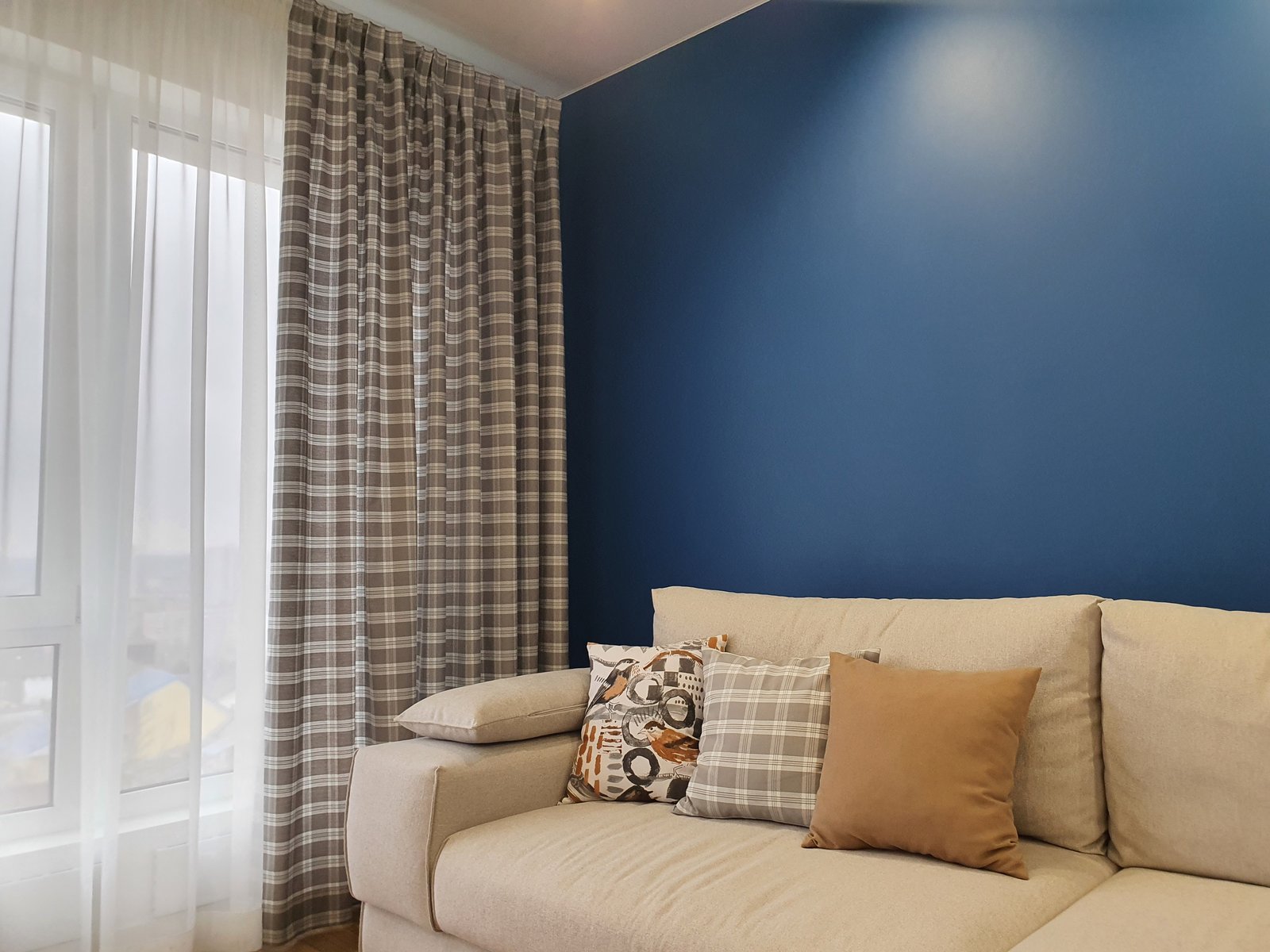 Checkered curtains with blue accent wall