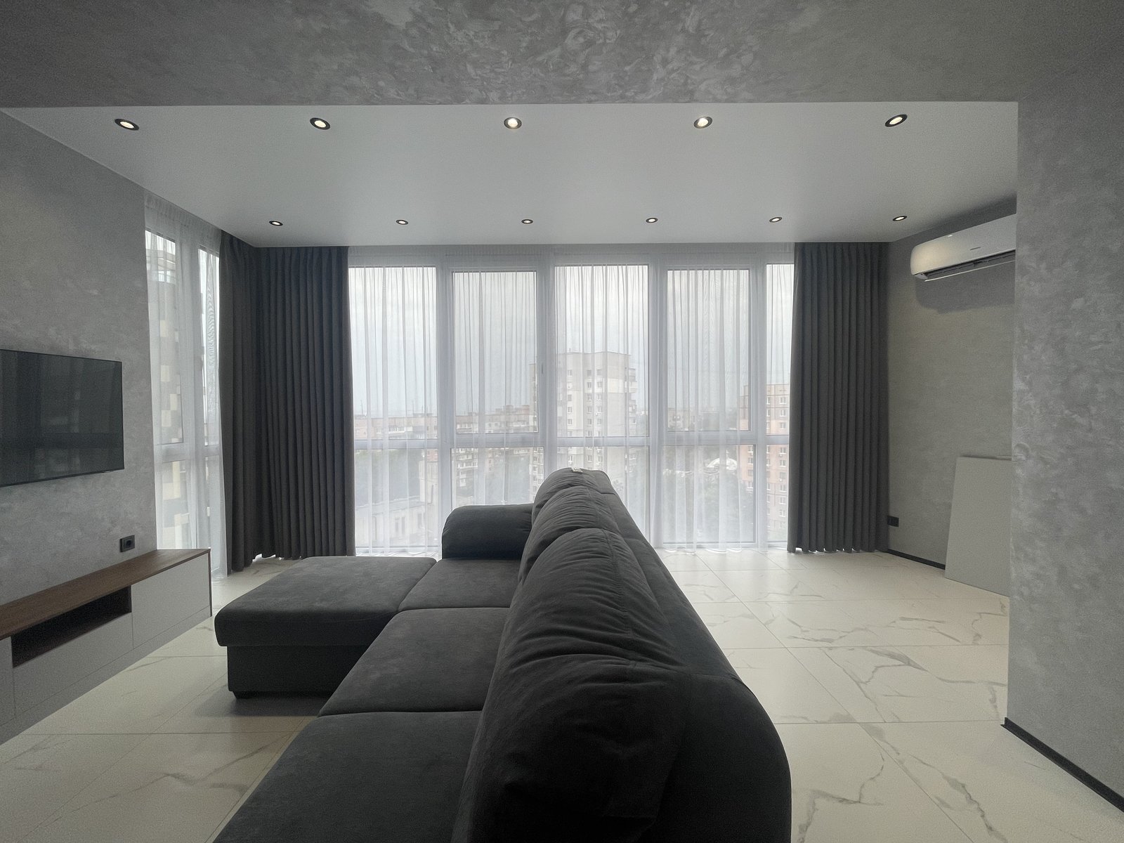 Living room with panoramic windows and dark curtains