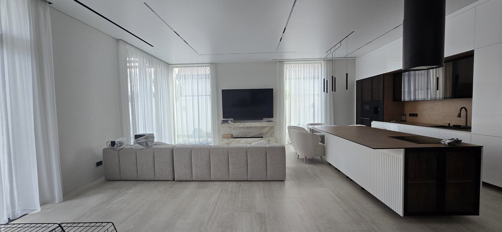 Open space living room with white curtains